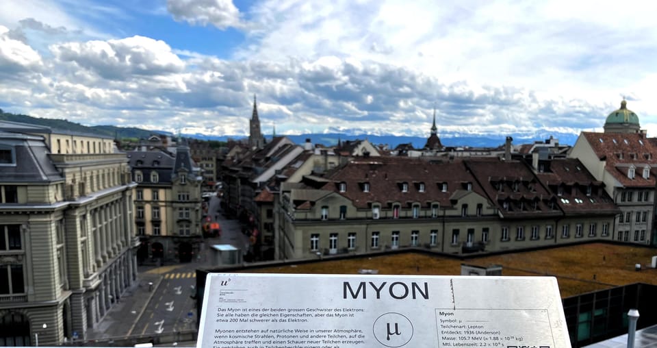 The skyline of Bern from the Grosse Schantze on a cloudy day, with one of the displays from University of Bern's quantum physics path (MYON) in the foreground.